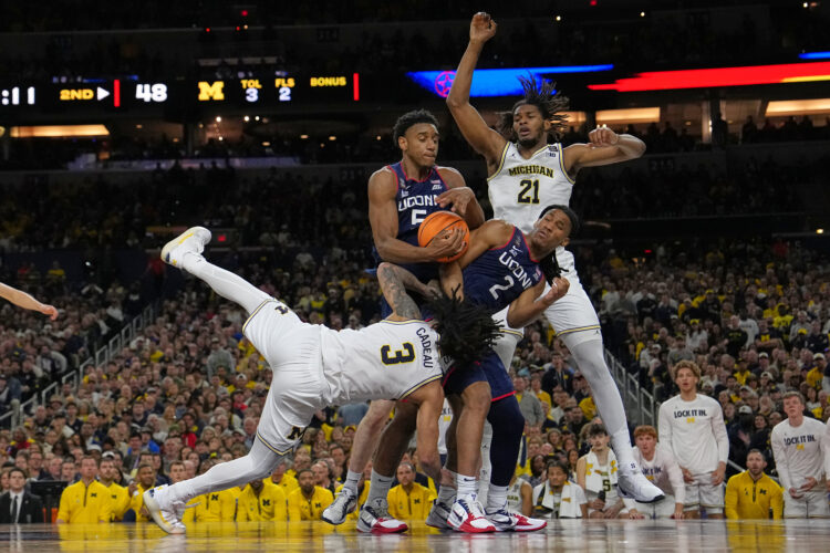 Michigan muscles its way to program’s 2nd national title, beating stubborn UConn